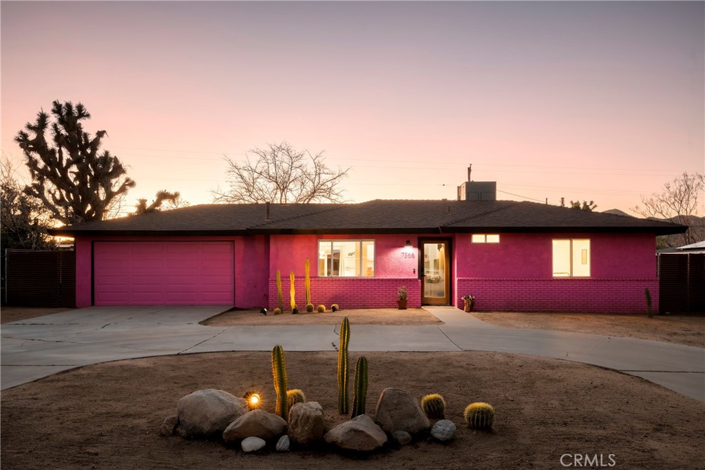 7566 Shawnee Trail Yucca Valley, CA 92284 - Photo 1 of 28 a front view of house with yard and garage