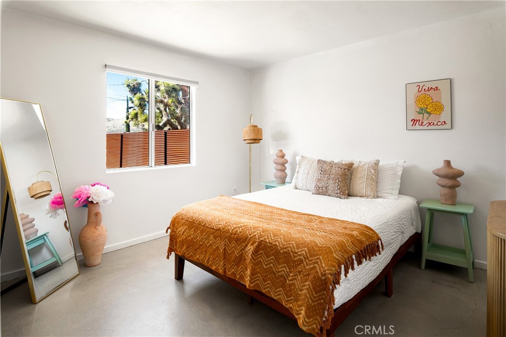 7566 Shawnee Trail Yucca Valley, CA 92284 - Photo 15 of 28 a bedroom with a bed and a window