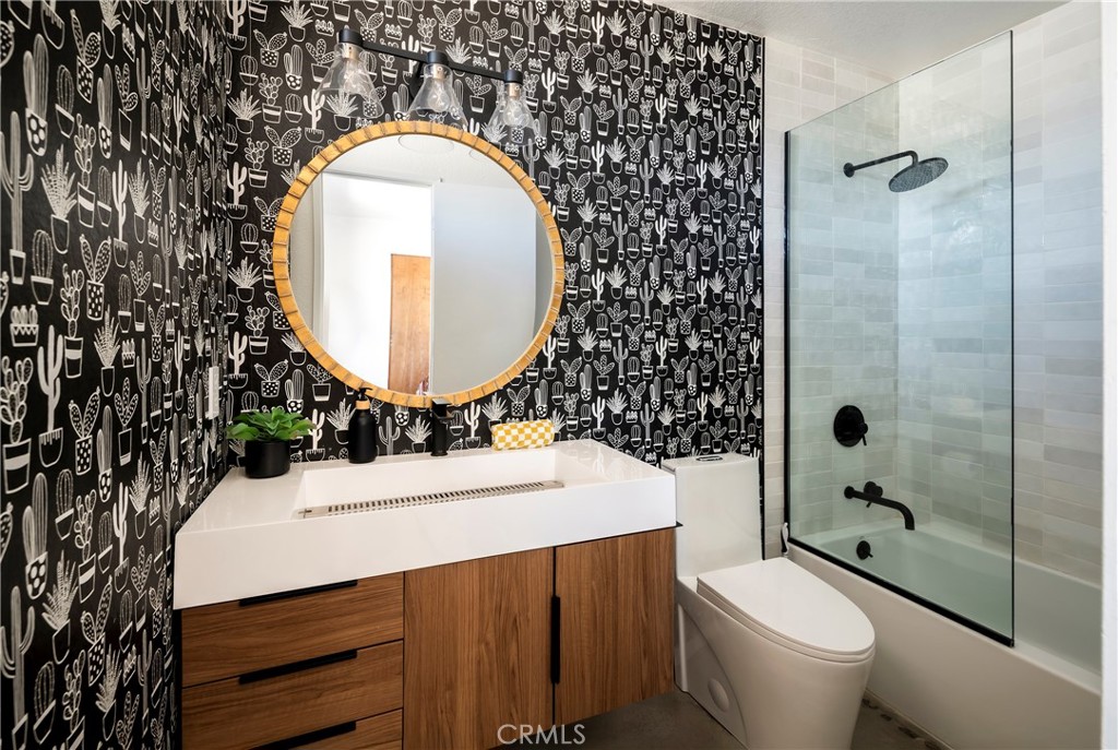7566 Shawnee Trail Yucca Valley, CA 92284 - Photo 20 of 28 a bathroom with a sink mirror toilet and shower