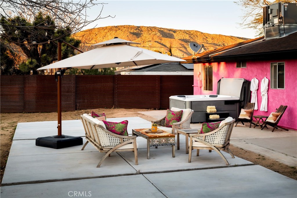 7566 Shawnee Trail Yucca Valley, CA 92284 - Photo 26 of 28 a patio with a table and chairs