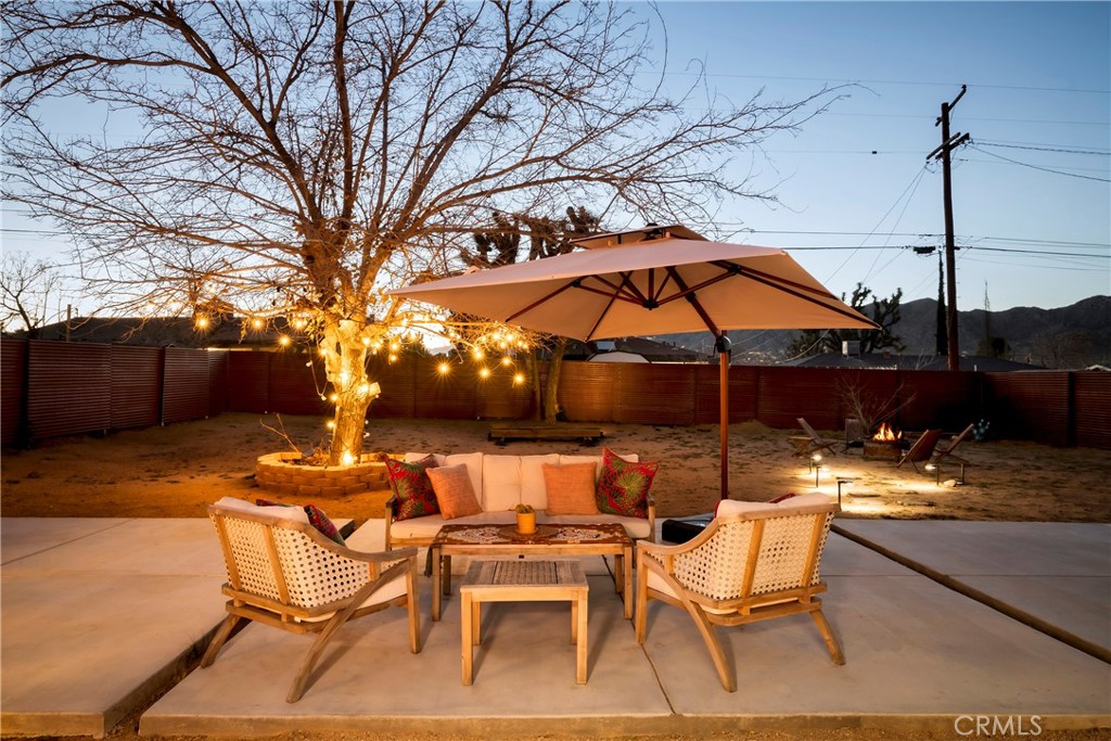7566 Shawnee Trail Yucca Valley, CA 92284 - Photo 28 of 28 a patio with a yard table and chairs