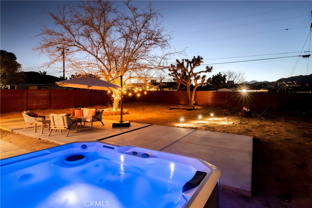 7566 Shawnee Trail Yucca Valley, CA 92284 - Photo 3 of 28 a view of a swimming pool with an outdoor space and seating area