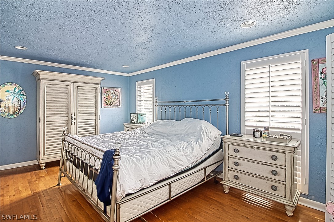 954 Sand Castle Road Sanibel, FL 33957 - Photo 22 of 29 a bedroom with a bed and a window