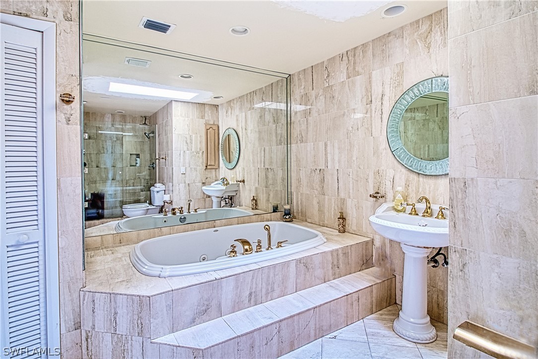954 Sand Castle Road Sanibel, FL 33957 - Photo 23 of 29 a bathroom with a sink and a mirror