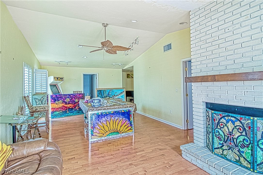 954 Sand Castle Road Sanibel, FL 33957 - Photo 5 of 29 a living room with stainless steel appliances furniture and a fireplace