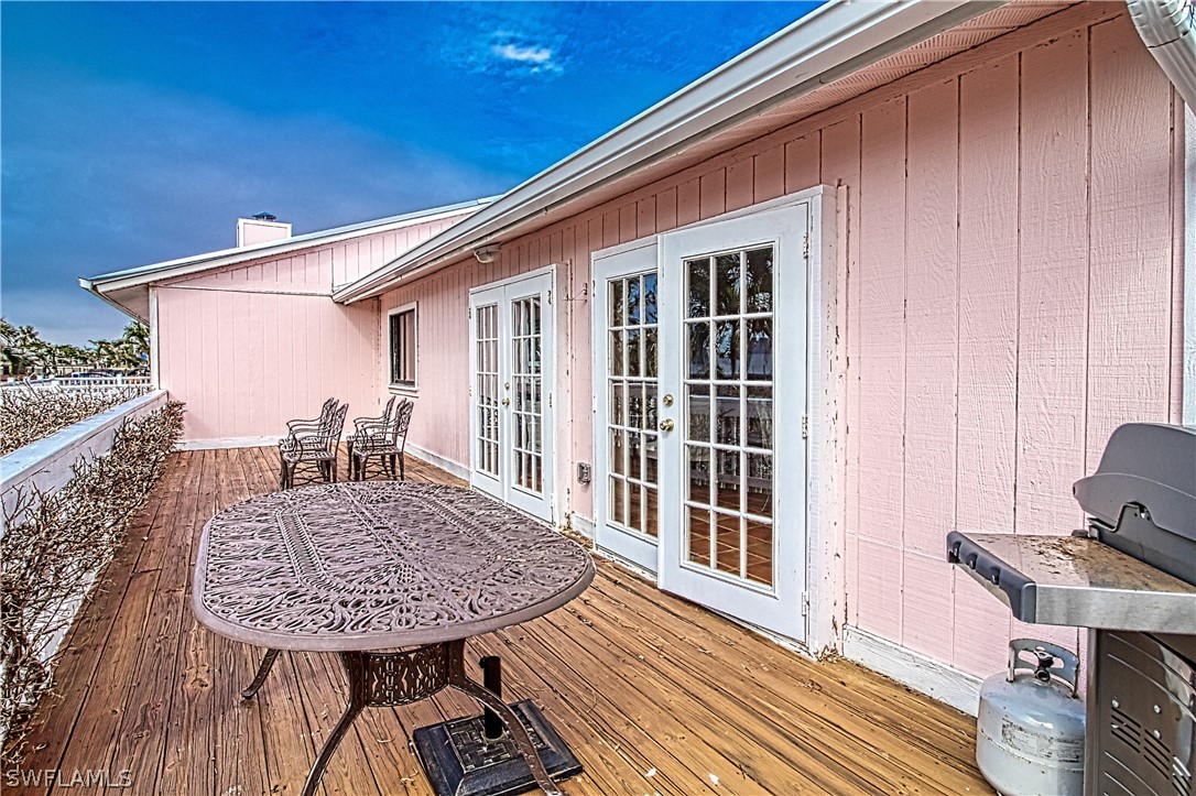 954 Sand Castle Road Sanibel, FL 33957 - Photo 8 of 29 a view of a balcony with a table and chairs