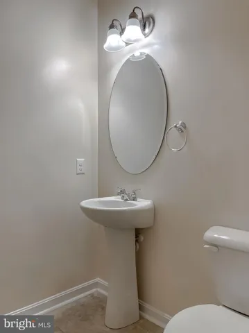 a white toilet sitting next to a bathroom sink