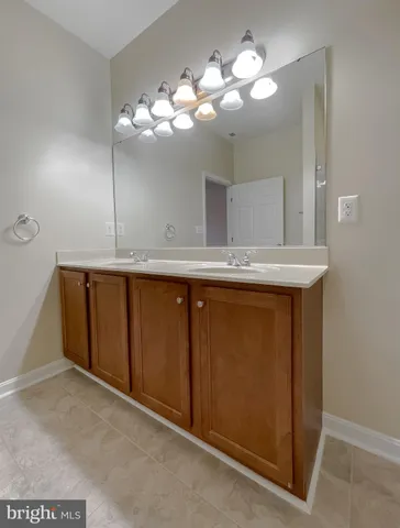 a bathroom with a granite countertop sink a toilet and a large mirror