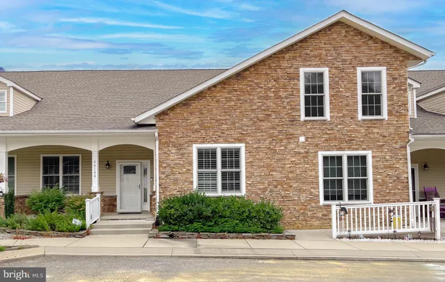 a kitchen with stainless steel appliances granite countertop a sink a stove top oven and wooden floors