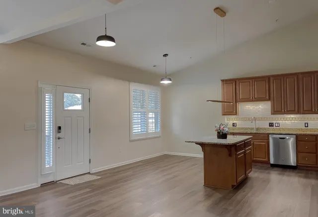 a kitchen with stainless steel appliances granite countertop a stove a sink dishwasher and a refrigerator