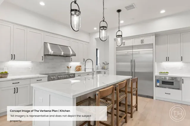 a kitchen with kitchen island a counter top space a sink stainless steel appliances and cabinets