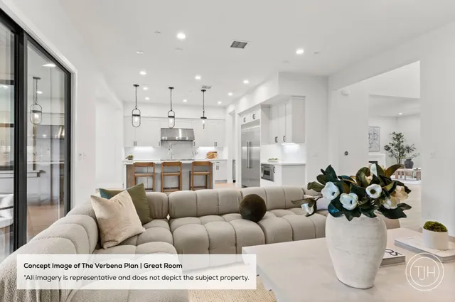 a living room with furniture kitchen and a chandelier
