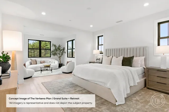 a spacious bedroom with a bed a couch and a large window