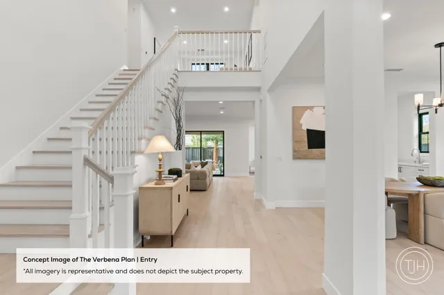 a view of a hallway with seating kitchen view and a chandelier