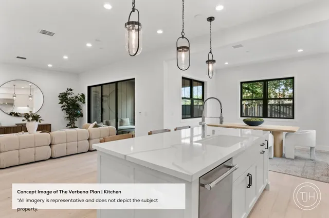 a large kitchen with stainless steel appliances a large center island attached withe living room