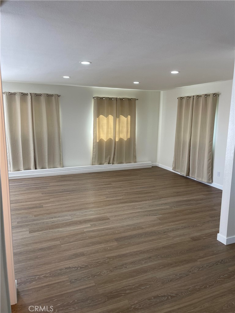 2643 Orange Street Riverside, CA 92501 - Photo 12 of 22 a view of an empty room with wooden floor and a window