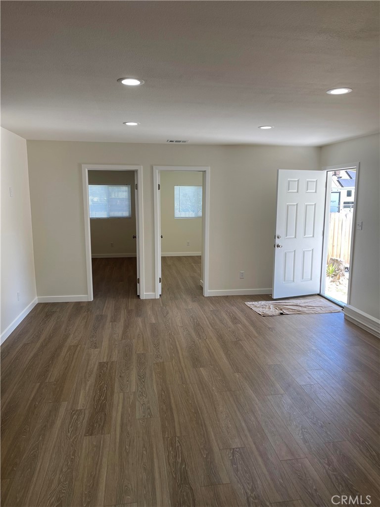 2643 Orange Street Riverside, CA 92501 - Photo 13 of 22 an empty room with wooden floor and windows