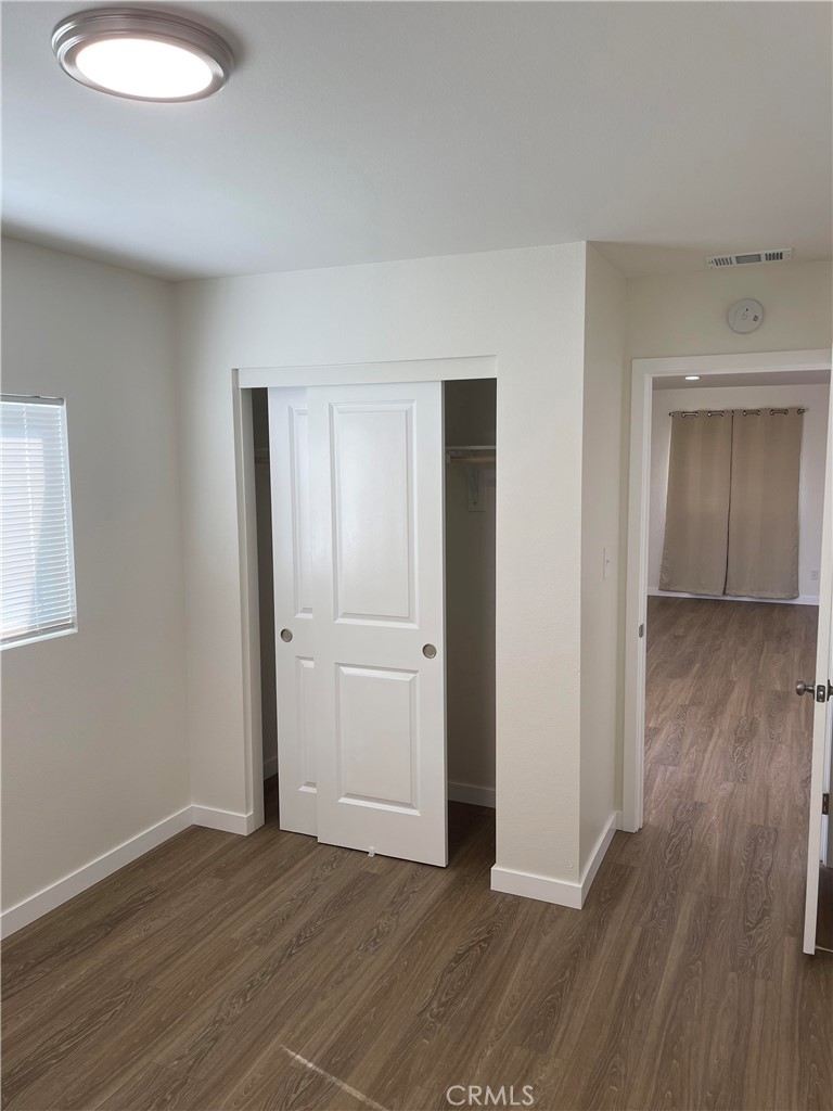 2643 Orange Street Riverside, CA 92501 - Photo 15 of 22 an empty room with wooden floor and closet
