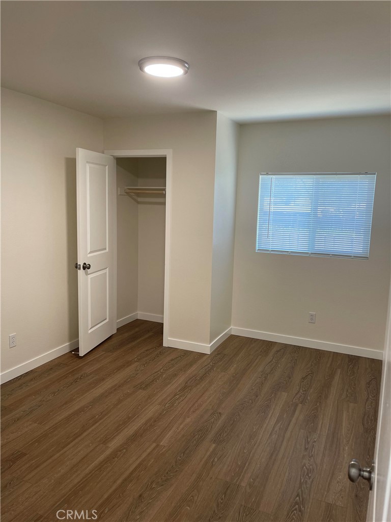 2643 Orange Street Riverside, CA 92501 - Photo 16 of 22 an empty room with wooden floor and windows