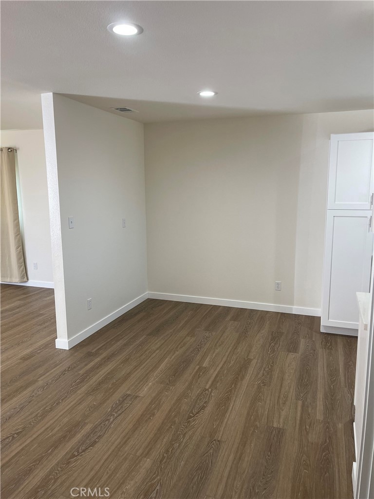 2643 Orange Street Riverside, CA 92501 - Photo 18 of 22 a view of an empty room with wooden floor and a window