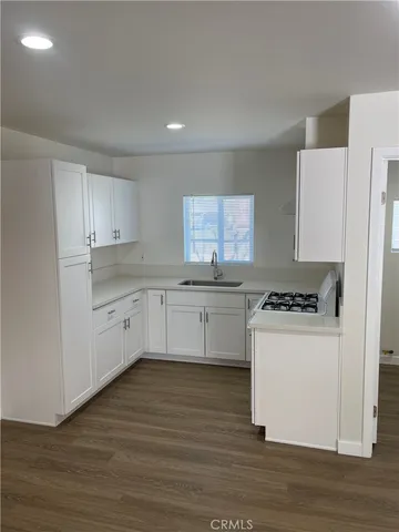 a kitchen with white cabinets and white appliances