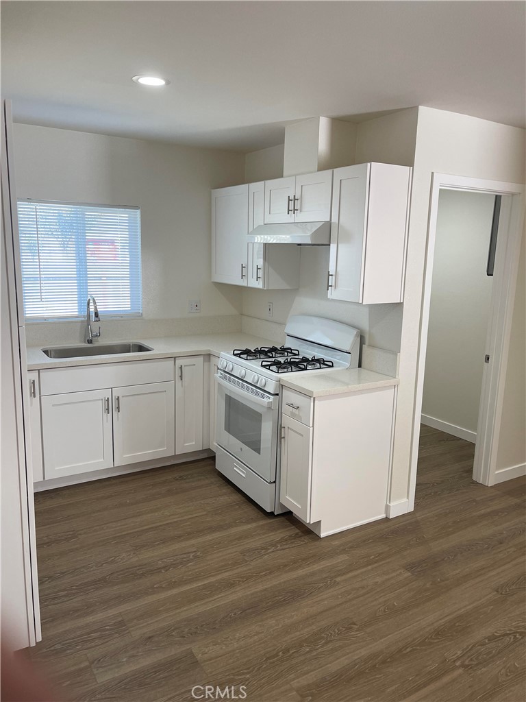 2643 Orange Street Riverside, CA 92501 - Photo 10 of 22 a kitchen with white cabinets and white appliances