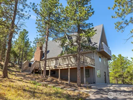 a front view of a house with a tree in it