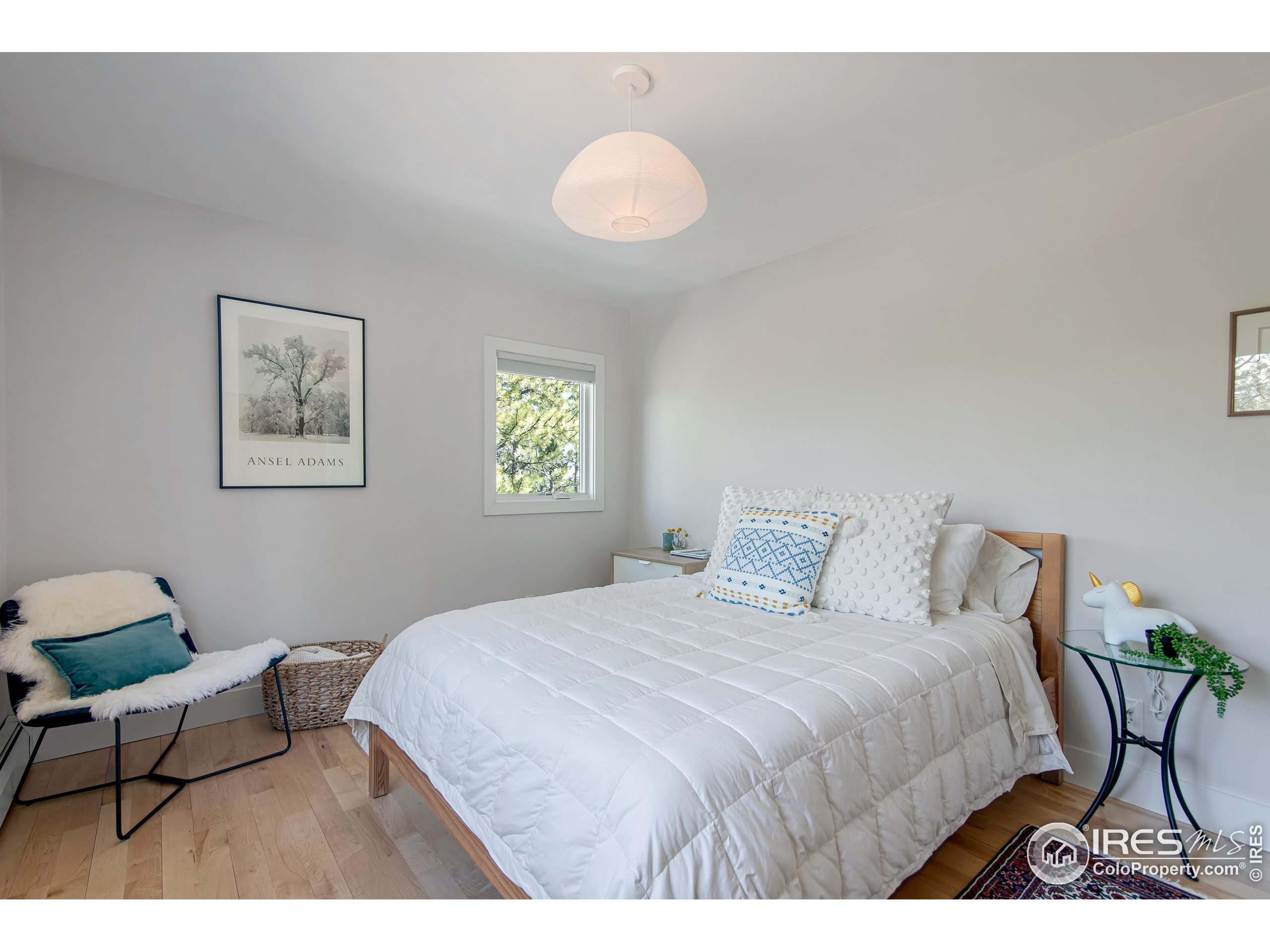 65 Bristlecone Way Boulder, CO 80304 - Photo 15 of 49 a bedroom with a bed and a chandelier