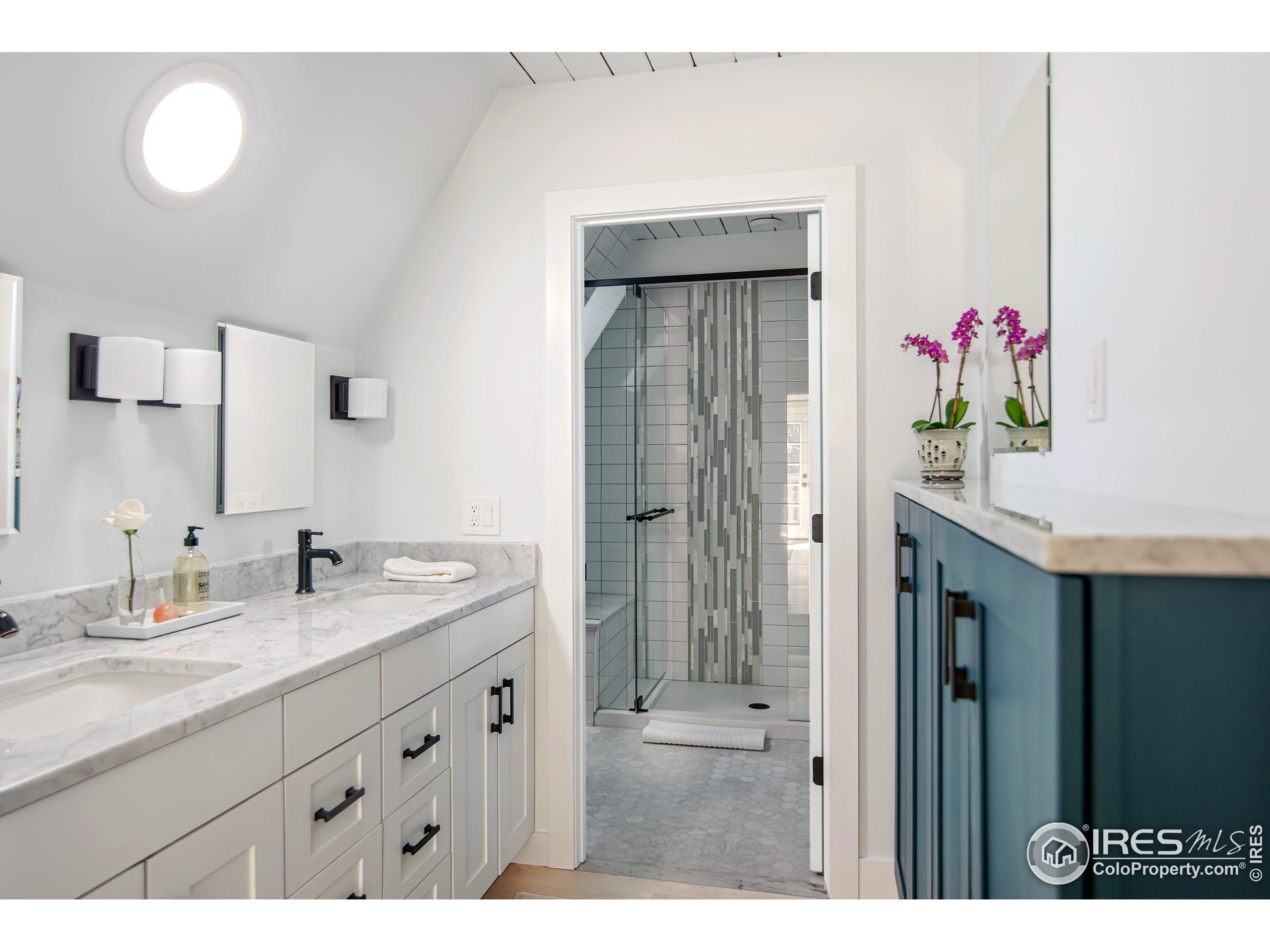 65 Bristlecone Way Boulder, CO 80304 - Photo 22 of 49 a bathroom with a granite countertop sink a large mirror a shower and a bathtub