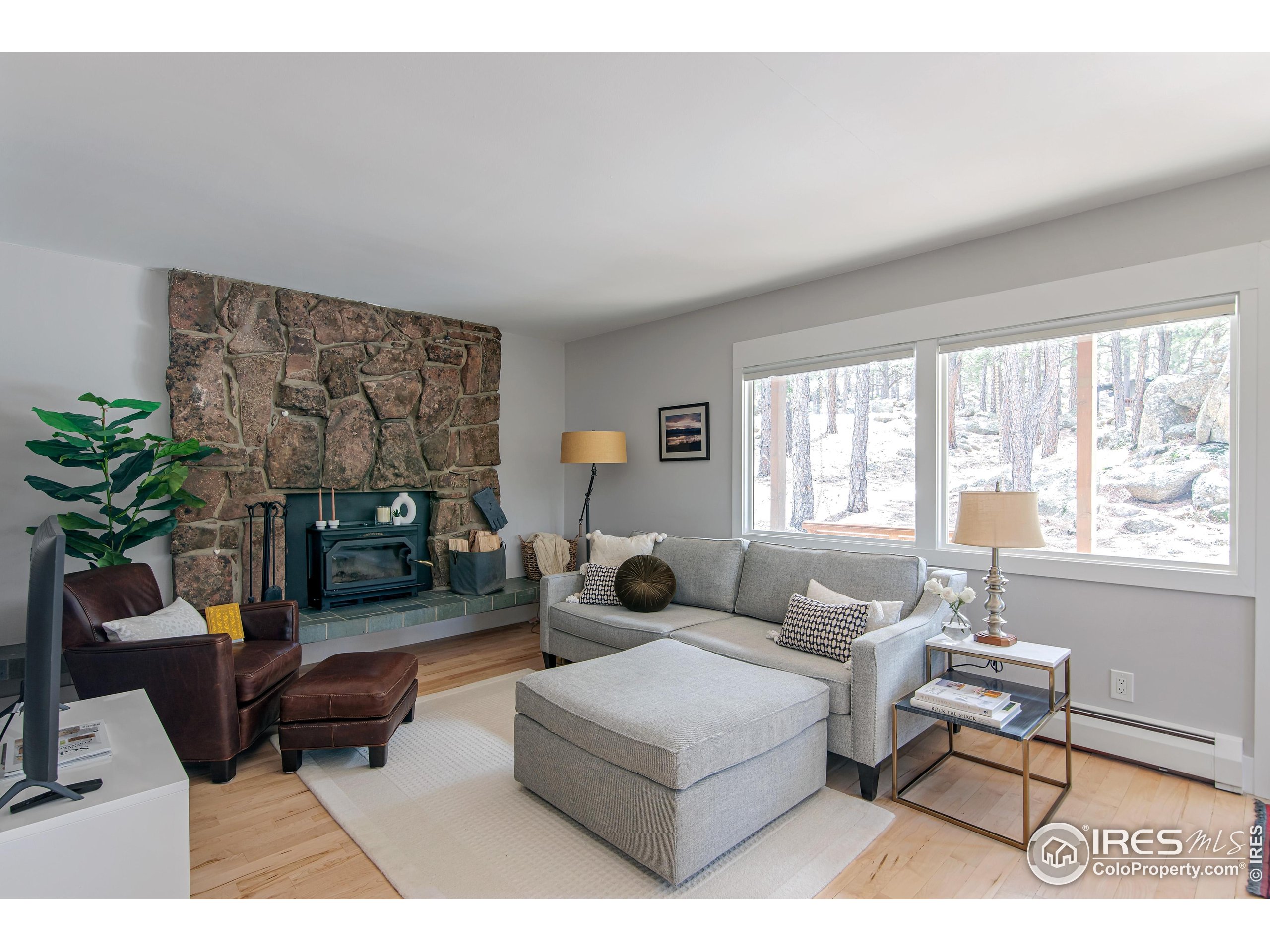 65 Bristlecone Way Boulder, CO 80304 - Photo 34 of 49 a living room with furniture large window and a flat screen tv