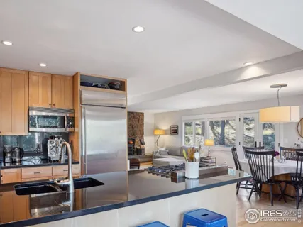a view of a kitchen with dining table and chairs