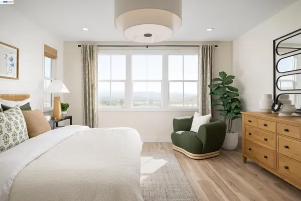 a bedroom with a bed and a large window