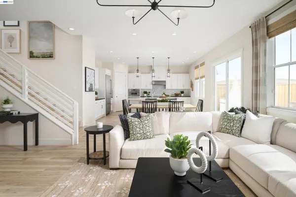a living room with furniture fireplace and a large window