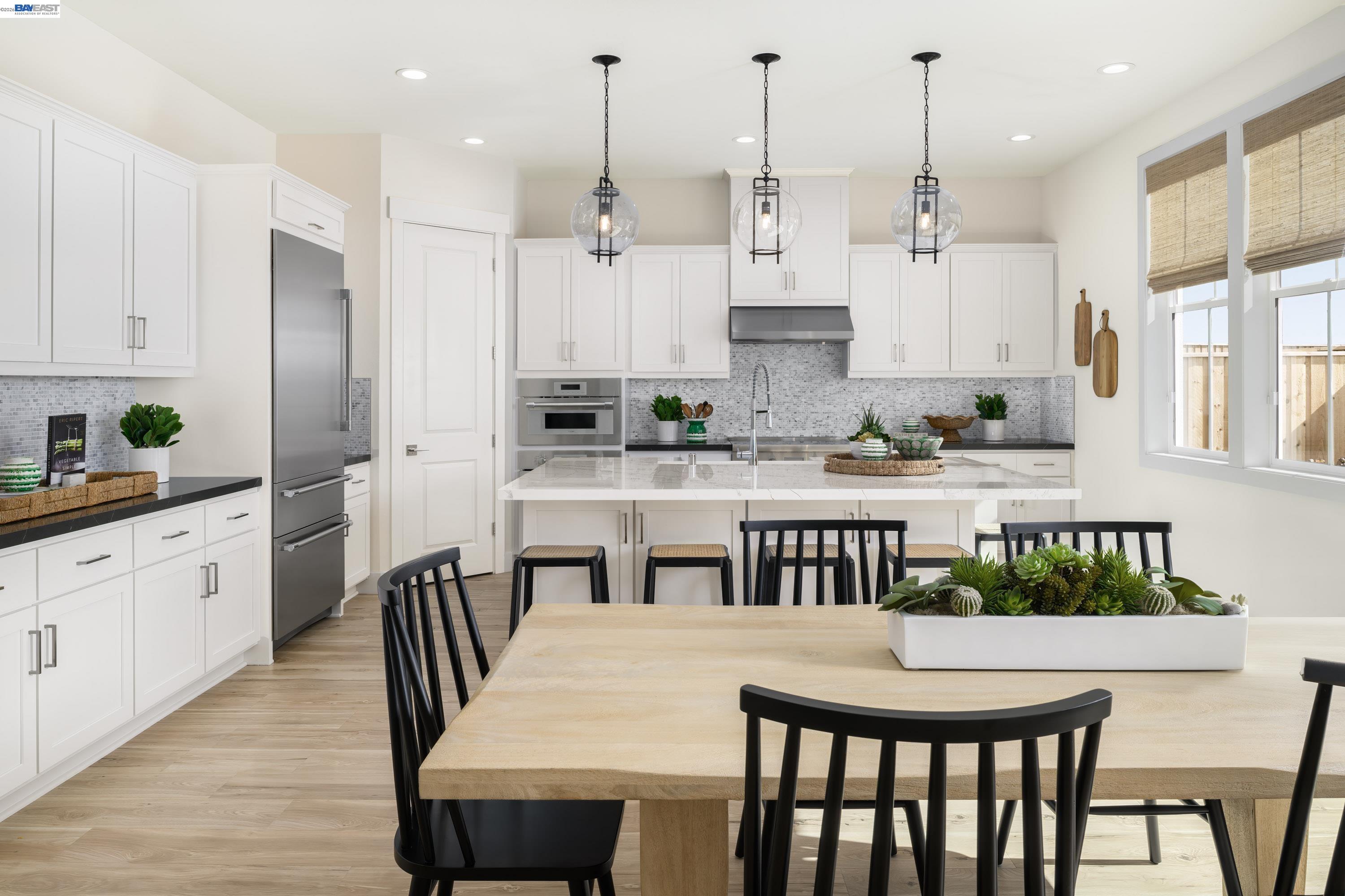 3868 Hereford Road Dublin, CA 94568 - Photo 5 of 22 a kitchen with stainless steel appliances kitchen island granite countertop a stove a sink a dining table and chairs