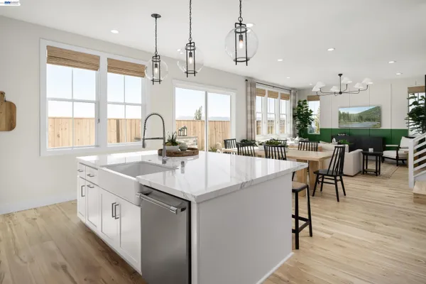 a kitchen with stainless steel appliances granite countertop a sink a counter space and a large window