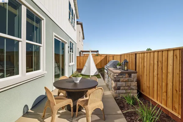 a backyard of a house with table and chairs