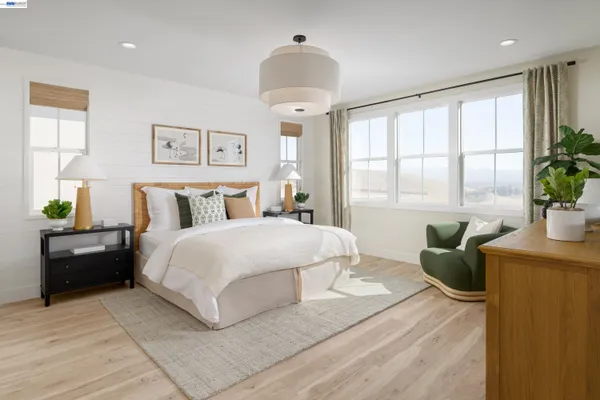 a bedroom with a large bed and a couch