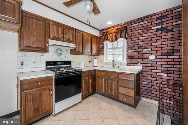 a kitchen with stainless steel appliances granite countertop a stove sink and cabinets