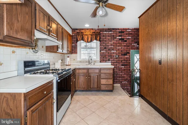 a kitchen with stainless steel appliances granite countertop a stove and a sink