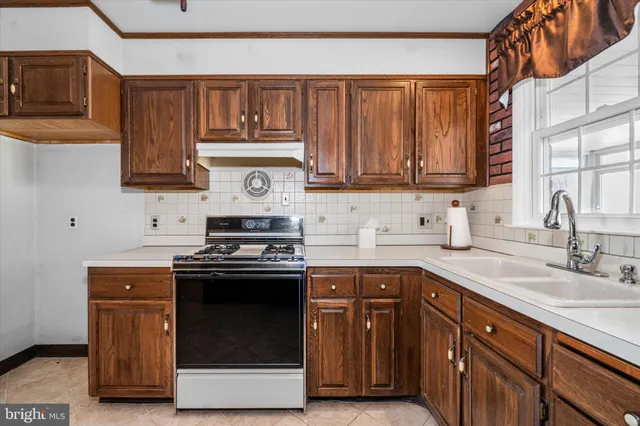 a kitchen with stainless steel appliances wooden cabinets and a stove top oven