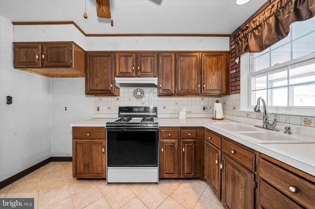 a kitchen with stainless steel appliances granite countertop a stove sink and cabinets