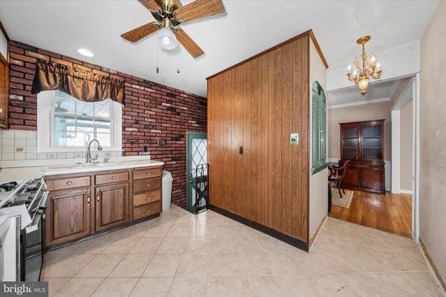 a spacious bathroom with a granite countertop sink a mirror and a bathtub