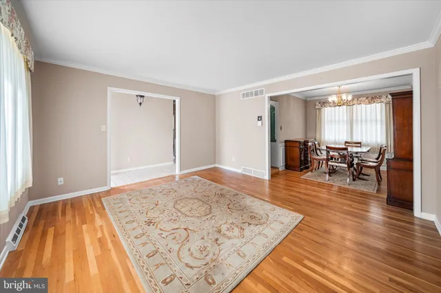 a living room with furniture rug and a table