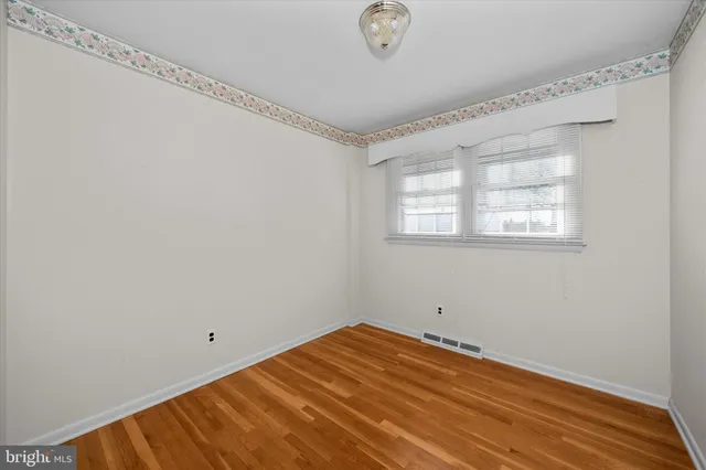a view of a room with wooden floor and windows