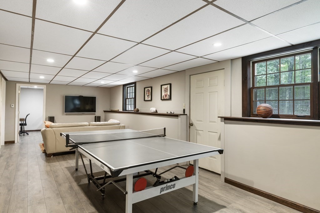 138 Lincoln Road Sutton, MA 01590 - Photo 23 of 35 a living room with stainless steel appliances furniture a flat screen tv and a table