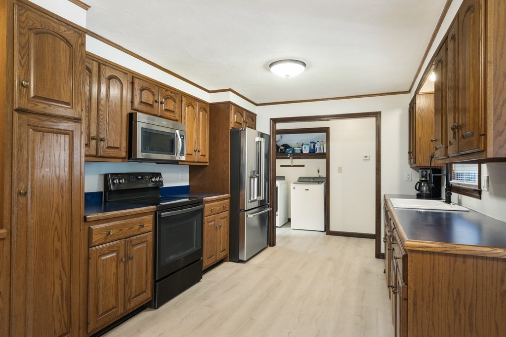 138 Lincoln Road Sutton, MA 01590 - Photo 6 of 35 a kitchen with stainless steel appliances granite countertop a refrigerator stove and sink