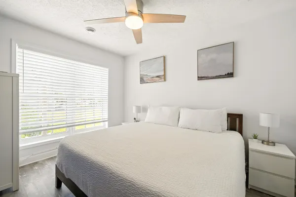 a bedroom with a large bed and a window