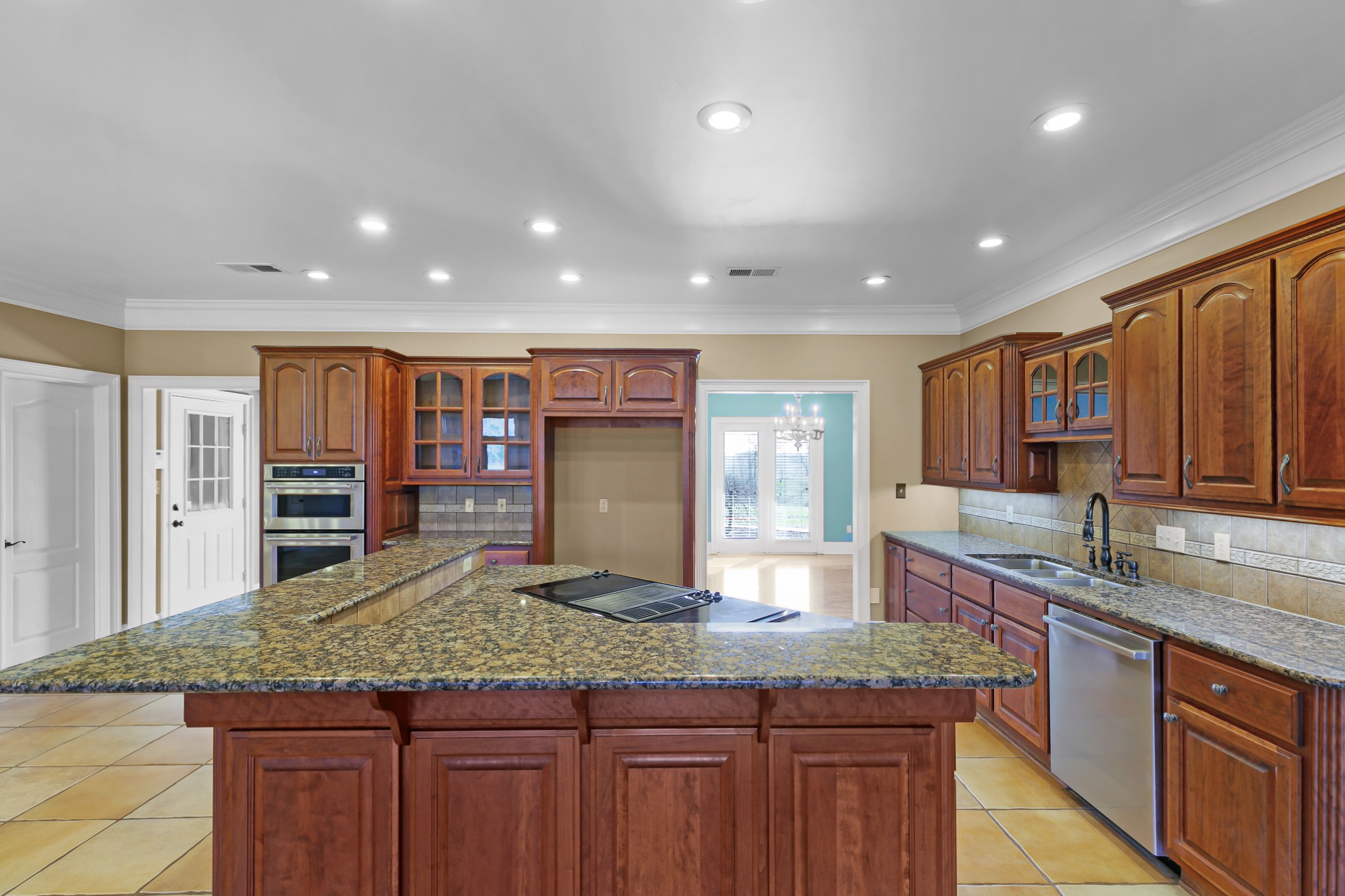 407 McLeary Road Jackson, TN 38305 - Photo 13 of 42 a kitchen with large counter space sink and wooden cabinets