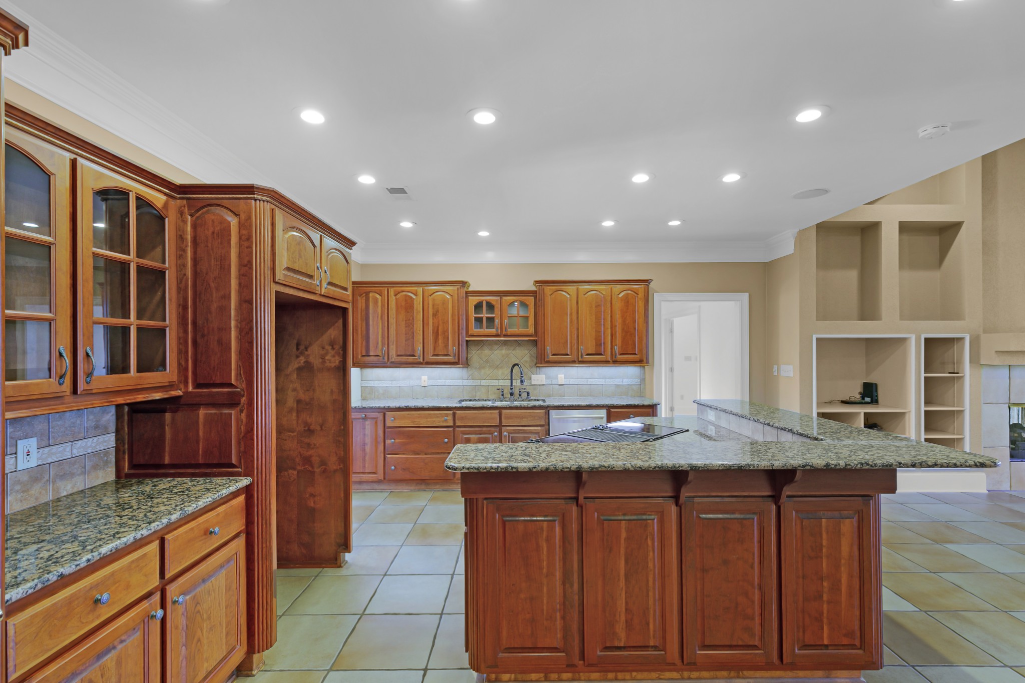 407 McLeary Road Jackson, TN 38305 - Photo 14 of 42 a kitchen with kitchen island granite countertop wooden cabinets a sink and dishwasher