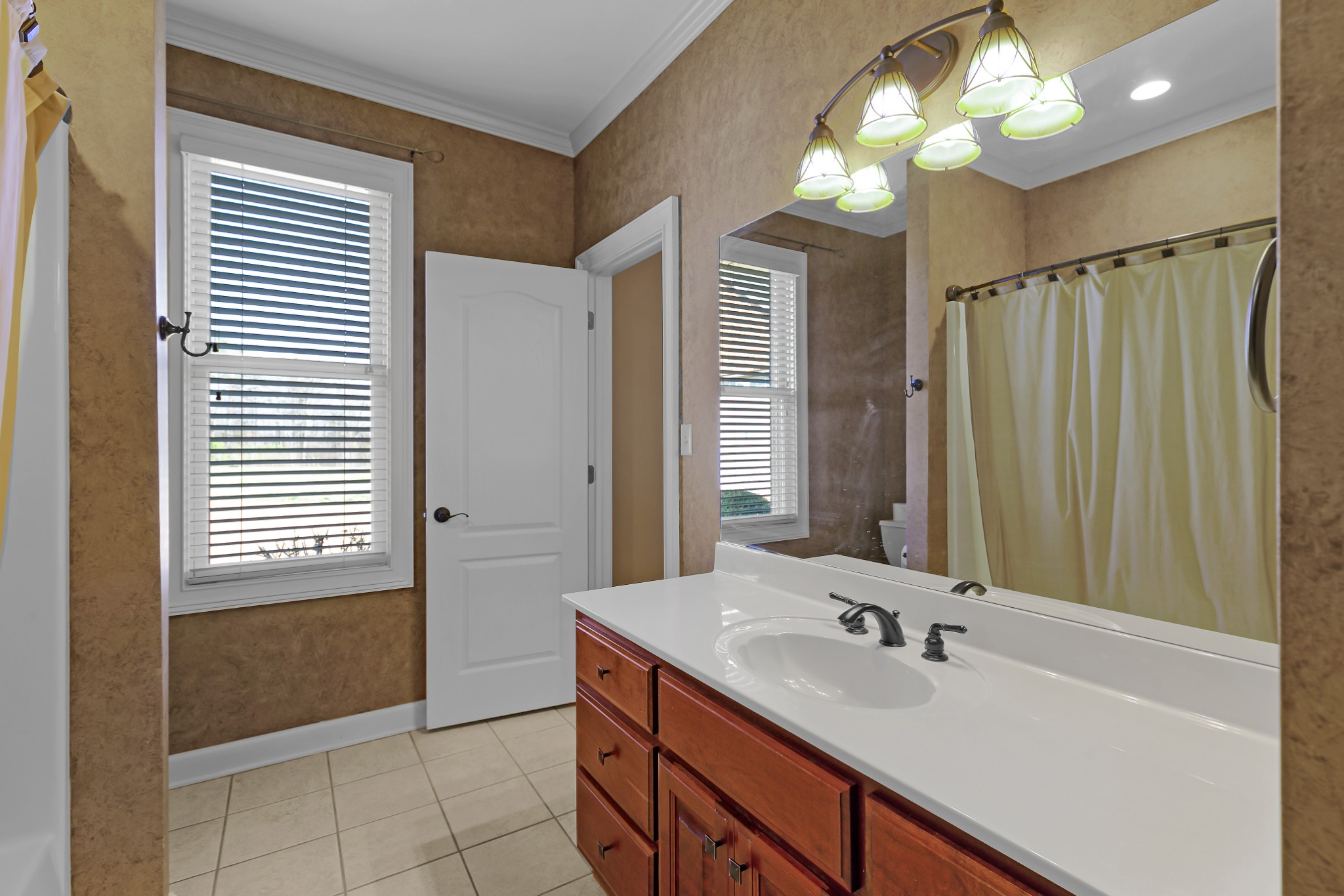407 McLeary Road Jackson, TN 38305 - Photo 22 of 42 a bathroom with a double vanity sink and a mirror